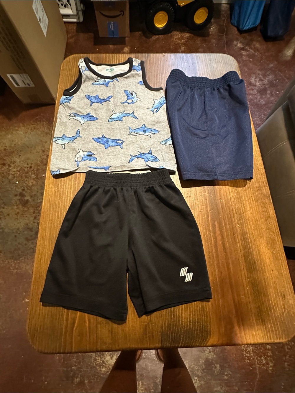 Tank Top with shark Print and two pairs of shorts.